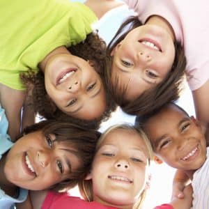 Kids smiling in circle.