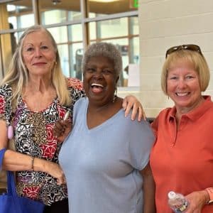 Three women enjoy a YMCA health fair.