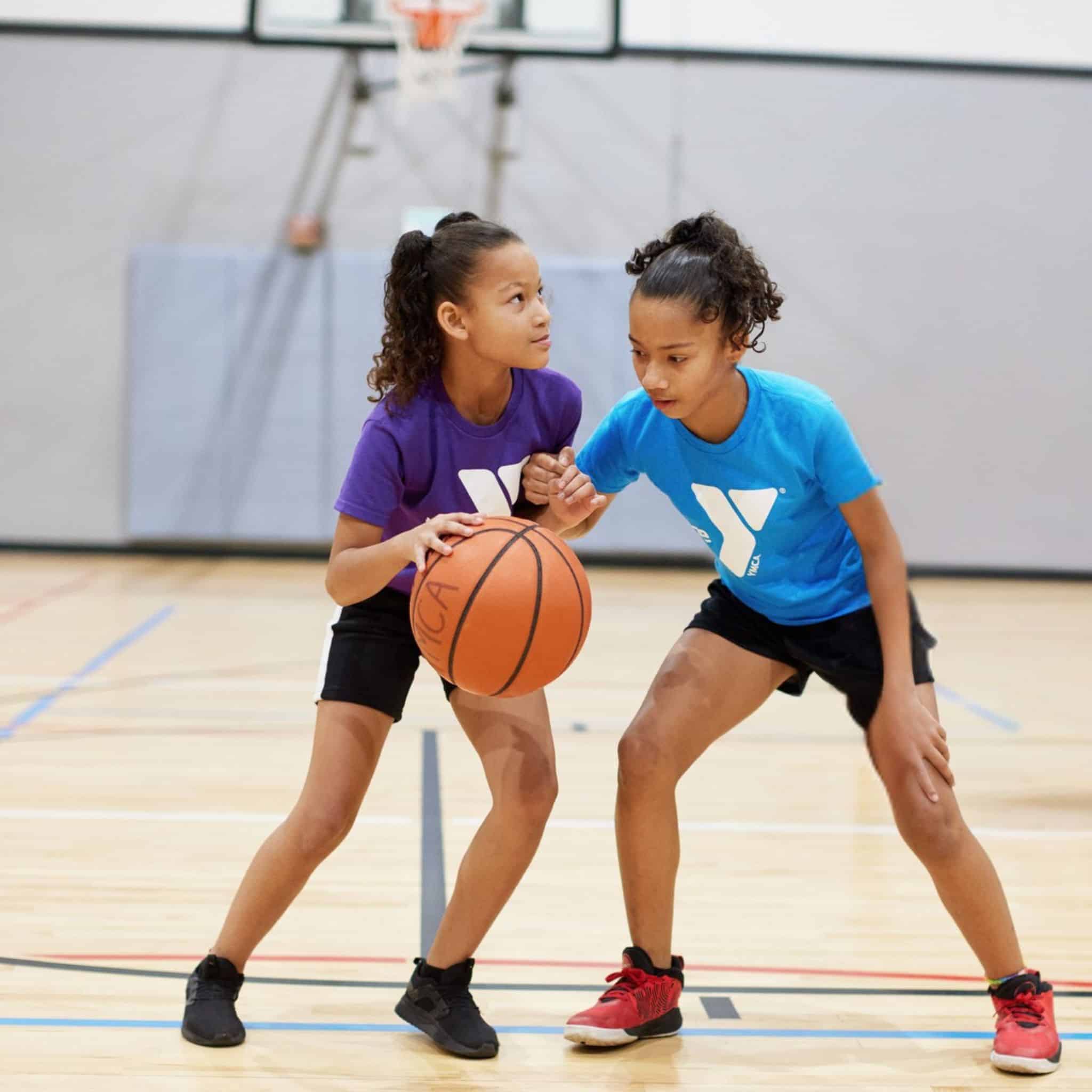 Girls playing basketball in a YMCA basketball program