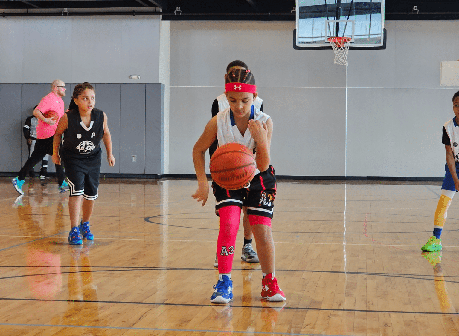 Girls in the YMCA basketball league play at a game.