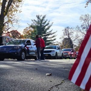 Witham Family YMCA staff serve boxed lunches to veterans and their families during the Tribute to Veterans Drive-Thru at Lebanon Memorial Park in Lebanon, Indiana.