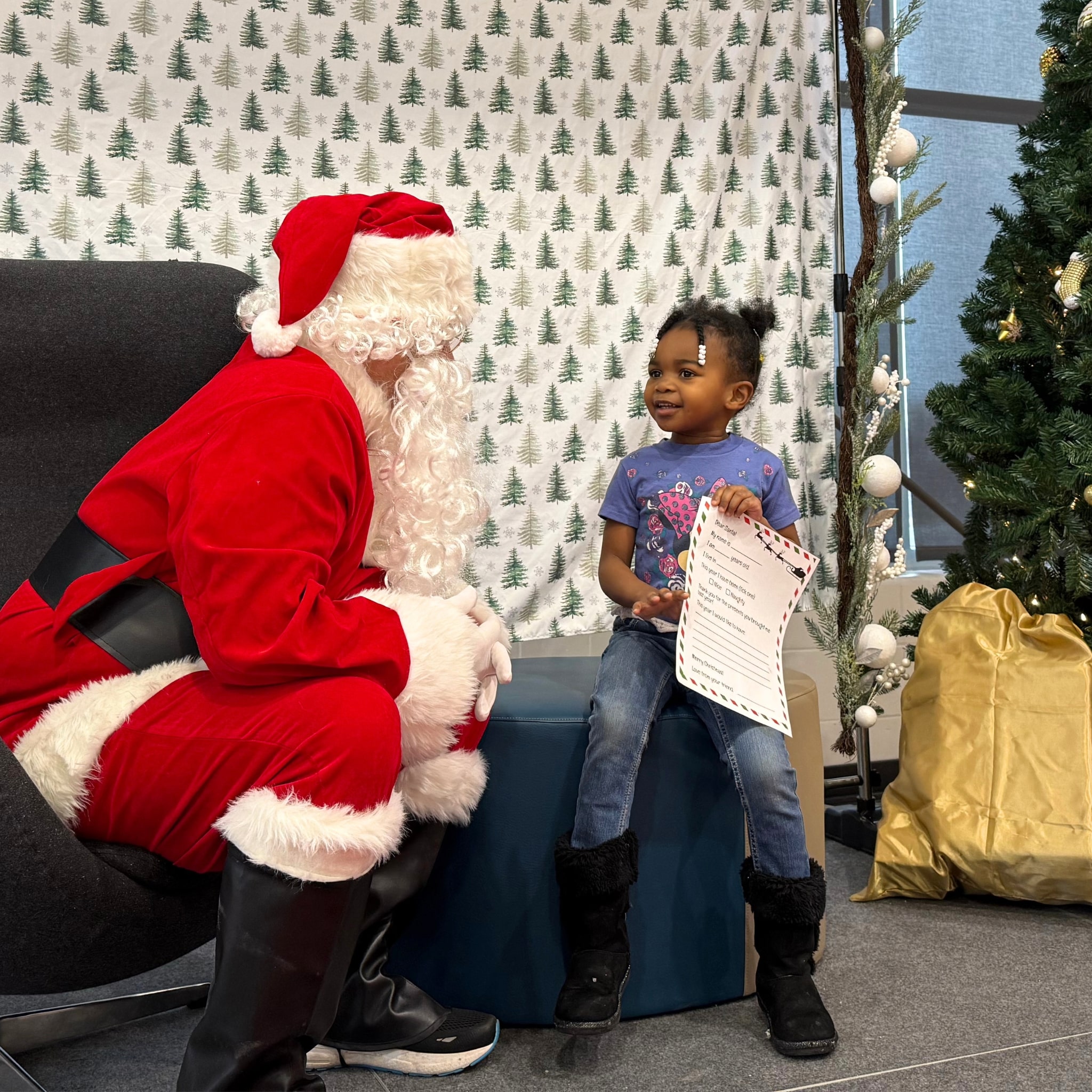 A young girl holds a letter to Santa while visiting Santa Claus at the Breakfast with Santa holiday event at the Ascension St. Vincent YMCA in Westfield