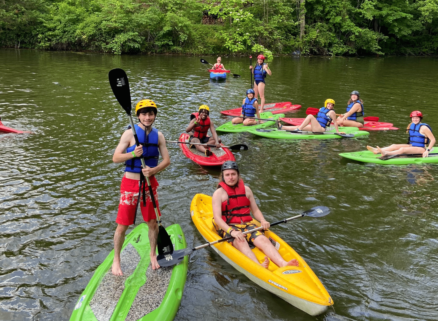 Campers paddle down the river at Flat Rock River YMCA Camp.
