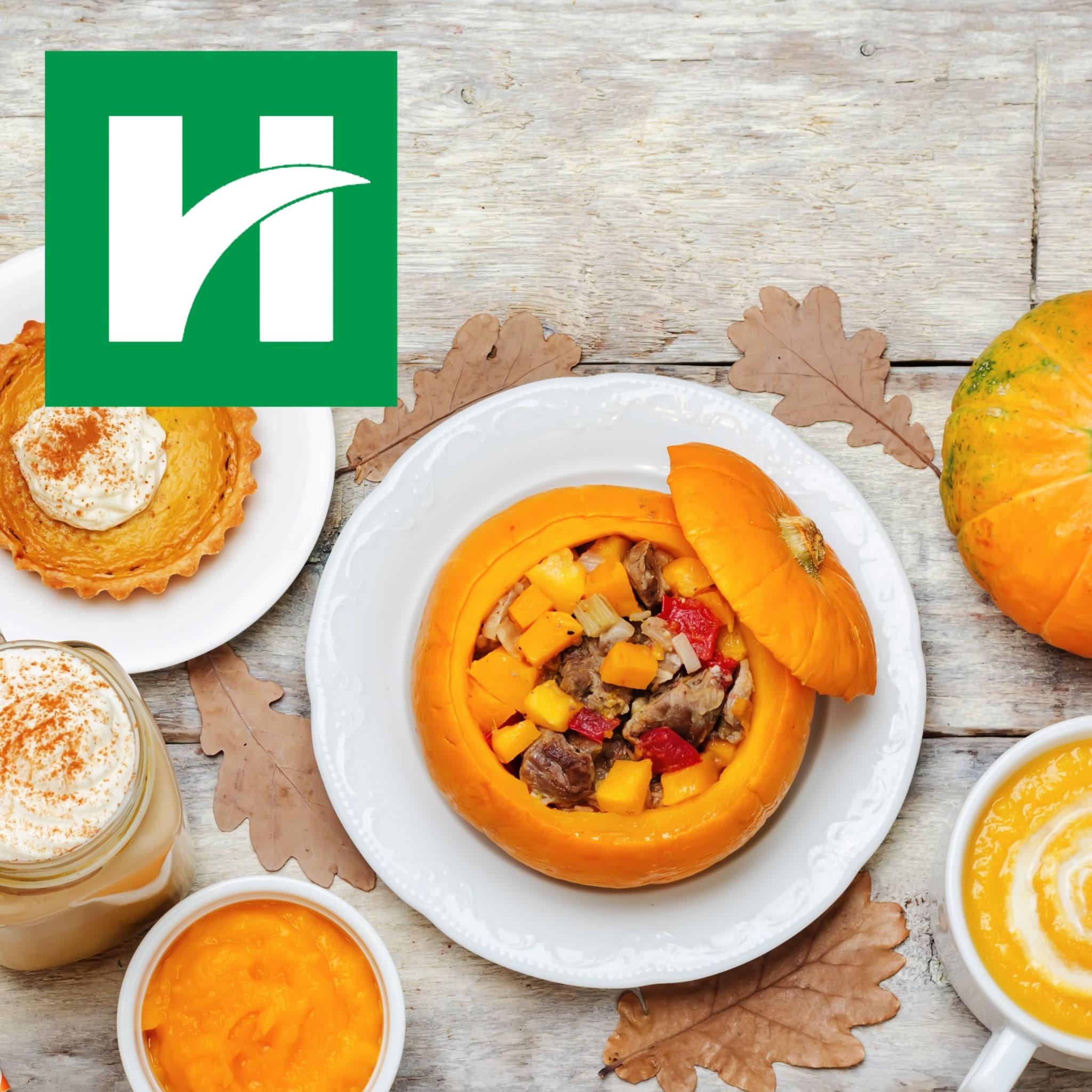 Pumpkin nutrition spread featuring a stuffed roasted pumpkin, pumpkin soup, pumpkin puree and pumpkin pie on a rustic table with fall leaves.